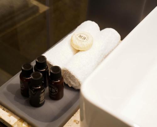 a group of five bottles of essential oils sitting on a towel at Antigua Hotel Boutique in Mexico City