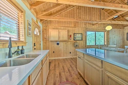 a kitchen with wooden walls and a wooden floor at Payson Cabin with Deck Views of the Mogollon Rim! in Payson