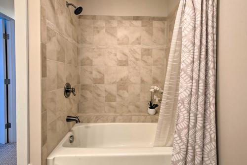 a white bath tub with a shower curtain in a bathroom at Large Yard and Games Edgewater Escape in Paupack! in Paupack