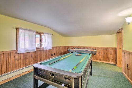 a pool table in a room with wooden walls at Charming Stanley Home with Yard, 7 Mi to Seneca Lake in Geneva