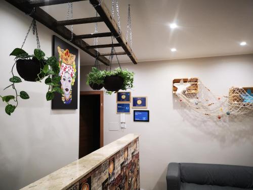 a room with potted plants on a wall at B&B Tonnarella Beach in Torre Forte
