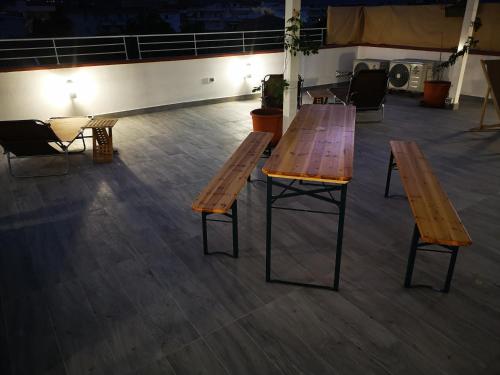 a group of wooden tables in a room with chairs at B&B Tonnarella Beach in Torre Forte