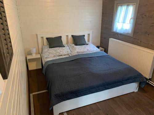 a bedroom with a large bed with two pillows at CERTO Nautica in Bratislava