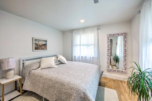 a bedroom with a bed and a mirror at Sunny Lancaster Gem, 4 Mi to Dutch Wonderland in Lancaster