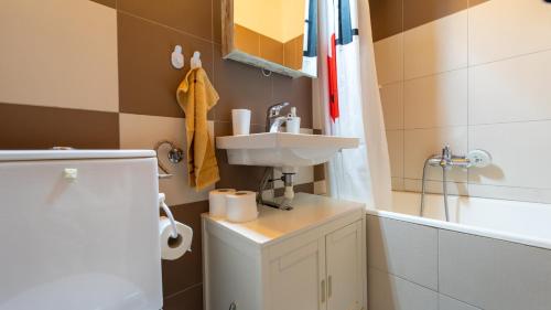 a small bathroom with a sink and a toilet at Holiday house Nature in Ravna Gora