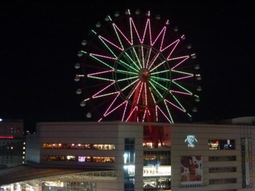 a large ferris wheel is lit up at night at Solaria Nishitetsu Hotel Kagoshima in Kagoshima