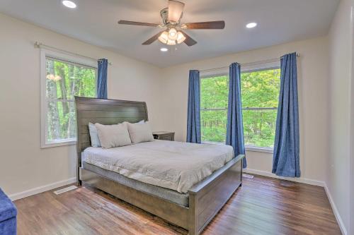 A bed or beds in a room at Poconos Family Getaway with Fire Pit and 2 Game Rooms