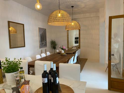 een eetkamer met een tafel met wijnflessen erop bij Villa Saint Charles in Juan-les-Pins