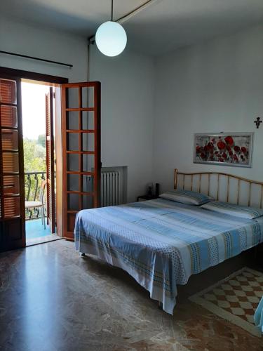 a bedroom with a bed and a sliding glass door at B&B Tio Pepe in Roseto degli Abruzzi