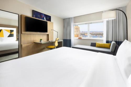 a hotel room with a bed and a television at M Social Hotel Times Square New York in New York