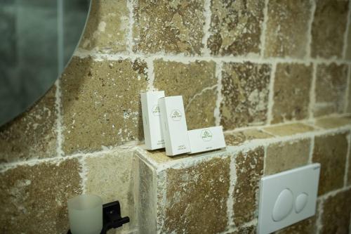 a bathroom with a stone wall with a sink at Ahiyan Hotel in Uchisar