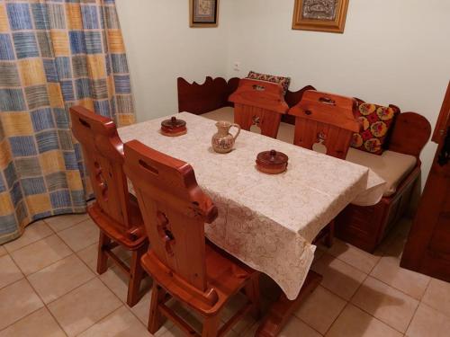 a dining room table with a white table cloth and chairs at Villa Anesis-Παραθαλάσσια βίλα in Amaliás