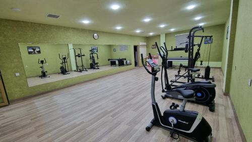 a gym with several exercise bikes in a room at Shane Hotel Quba in Quba