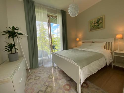 a bedroom with a bed and a large window at Zane's apartment in Valmiera
