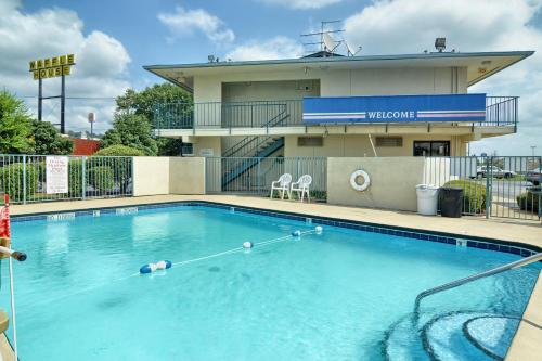 a large swimming pool in front of a hotel at Skyline Inn in Conway