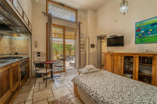 a bedroom with a bed and a sink and a desk at Domus Vesuvia in Torre Annunziata