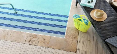 a view of a pool with a hat and a cup at Homewood Suites By Hilton Ann Arbor in Ann Arbor