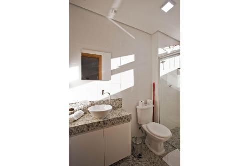 a bathroom with a toilet and a sink at Locking's Lourdes 10 in Belo Horizonte