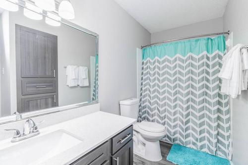 a bathroom with a sink and a toilet and a shower at SoCo Chic Apartment Suites Close to Downtown in Austin