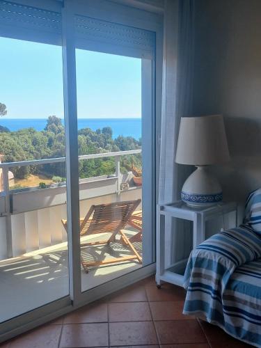 a bedroom with a balcony with a view of the ocean at vista sul blu ,Baia Blu, Lerici in Lerici