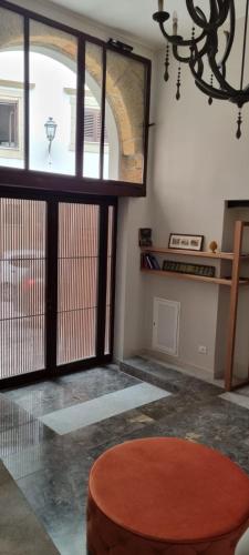 a living room with a table and a large window at Isula in Palermo