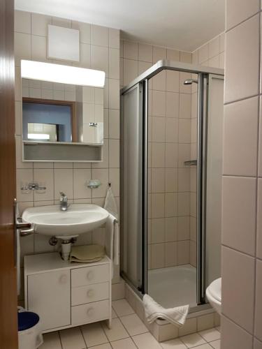 a bathroom with a sink and a shower at Gasthaus Beverin in Fardün