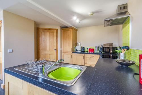 a kitchen with a green sink in a kitchen at The New Chapel in Goxhill