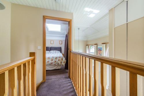a hallway leading to a bedroom with a bed at The New Chapel in Goxhill