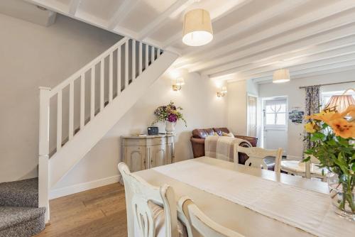 a dining room and living room with a table and chairs at 2 Bryn Tirion in Tanygrisiau