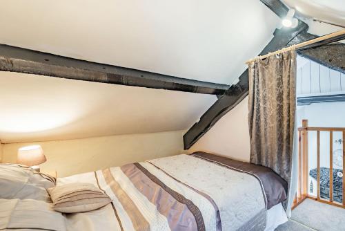 a bedroom with a bed and a window at Henrhiw Bach in Dolwyddelan