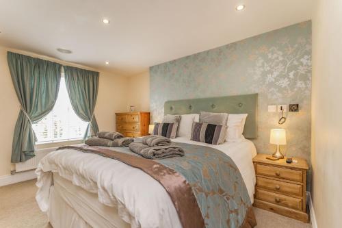 a bedroom with a large bed and a window at Fisher Cottage in Hornsea