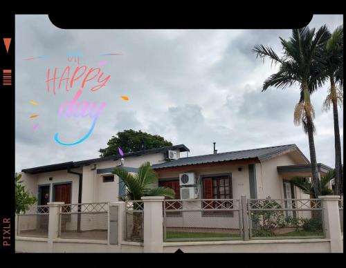 a house with a happy forever sign in front of it at EL AURA in Federación