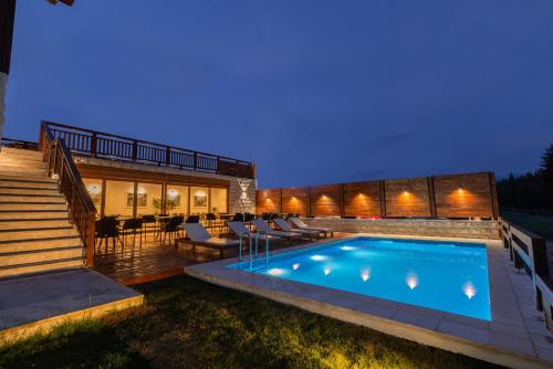 a swimming pool in the backyard of a house at NORTH STORY - Luxury Chalet - Apartments & rooms in Žabljak
