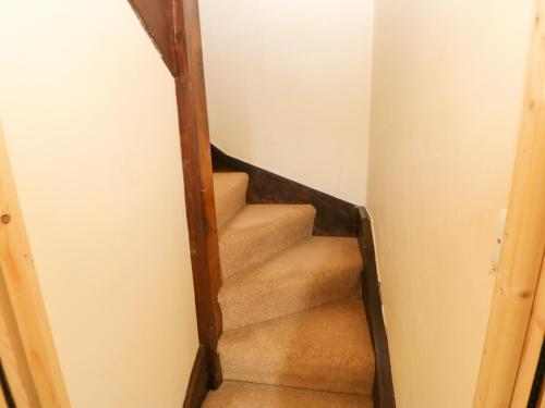 a stairway in a house with a stair case at 89 High Street in Kirkby Stephen