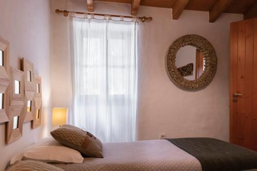 a bedroom with a bed and a mirror on the wall at Casas de Campo do Castro da Cola in Marchicão