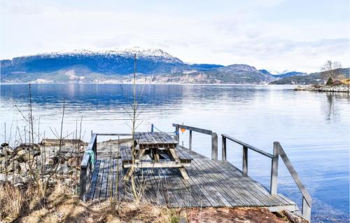 a dock on a lake with a mountain in the background at 3 Bedroom Lovely Home In Kysnesstrand in Gausvik