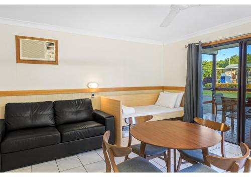 a living room with a couch and a table at Discovery Parks - Mackay in Mackay