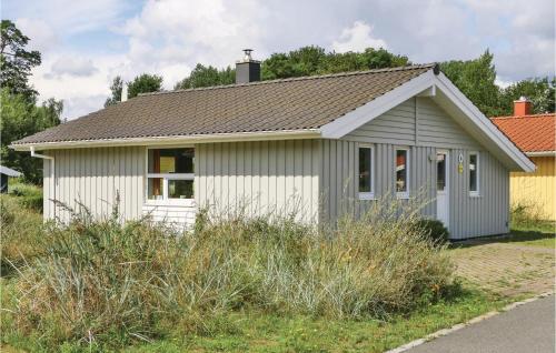 a small white house with a gray roof at Abendrot 6 - Dorf 3 in Priwall
