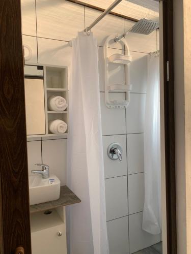 a bathroom with a shower curtain and a sink at AURA ECO SUITE in La Paz
