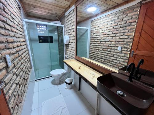 a bathroom with a sink and a glass shower at Villa Flecheiras in Flecheiras