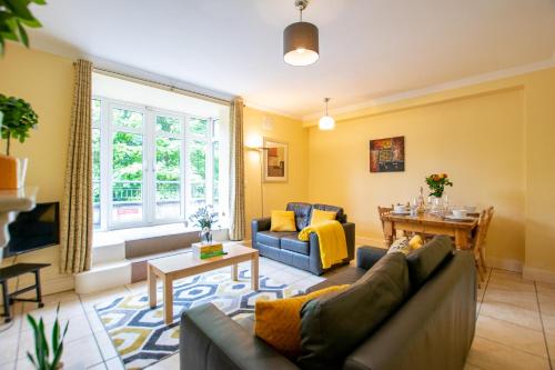 a living room with a couch and a table at 126 - Gort Na Coiribe 4 Bedroom Duplex, by Shortstays in Galway