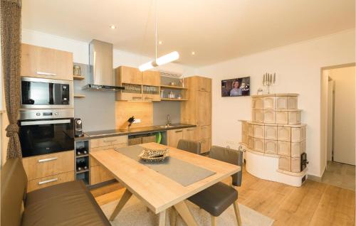 a kitchen with a wooden table and a dining room at Schönes Ferienhaus Eisenberg in Eisenberg an der Pinka
