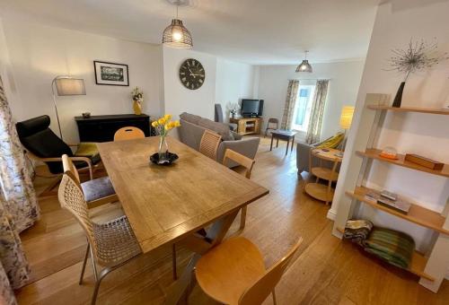 a living room with a dining table and a living room at The Knots-Spacious 3 bedroom apartment in Bridport in Bridport