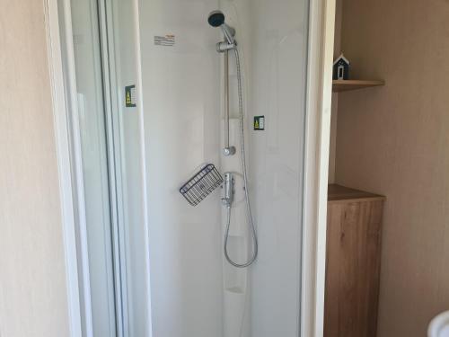 a shower with a shower head in a bathroom at 8 Berth blow heated on Sealands New Horizon in Ingoldmells