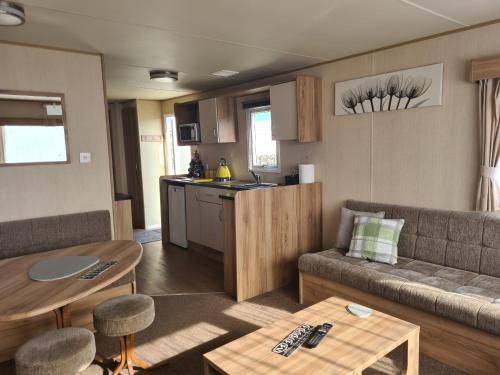 a living room with a couch and a table at 8 Berth blow heated on Sealands New Horizon in Ingoldmells