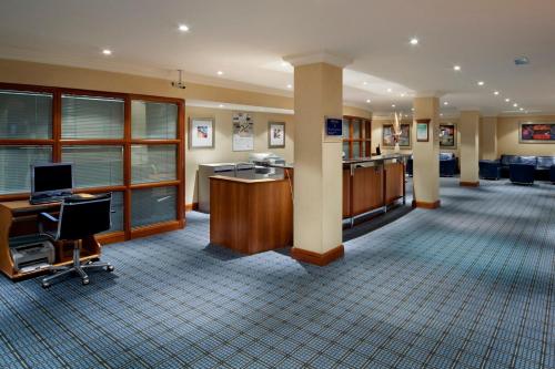 a lobby of an office with a desk and a computer at Holiday Inn - Glasgow Airport by IHG in Paisley