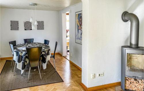 a dining room with a table and chairs and a fireplace at Awesome Home In Ystad With 1 Bedrooms And Wifi in Ystad