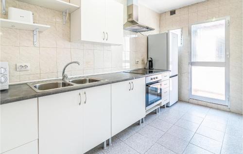 a white kitchen with white cabinets and a sink at Gorgeous Apartment In Cordoba With Wifi in Córdoba
