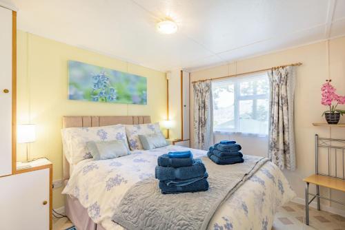 a bedroom with a bed with blue towels on it at Bluebell Cottage in Llanrwst