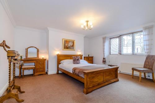 a bedroom with a bed and a desk and a chair at The Bolthole in Whitby